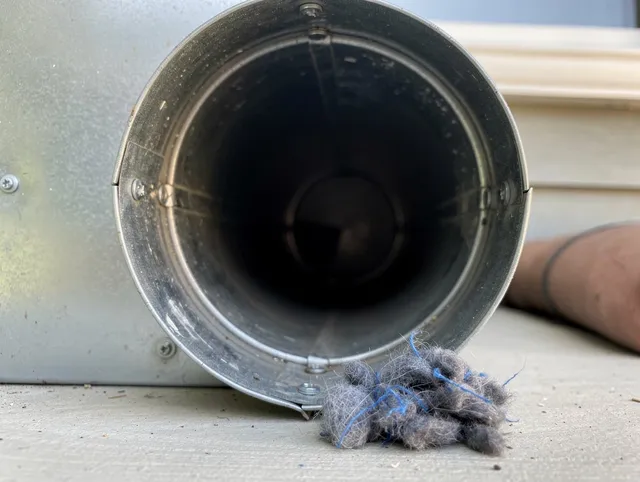 North Reading Dryer Vent Cleaning technician using specialized equipment to clear severe dryer vent blockage in North Reading